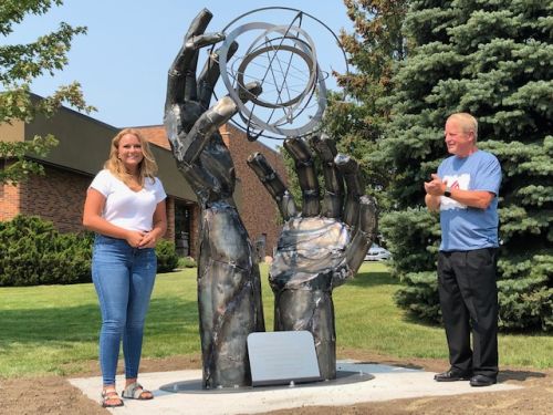 Metal sculpture entitled “Reach” unveiled on the Lake Area Technical College campus  (Audio)