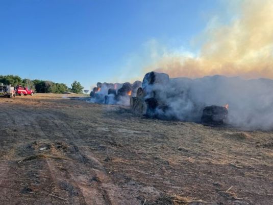 Large hay bales destroyed by fire on farm west of Watertown