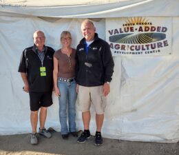 Ag Director Chuck Langner and News Director Mike Tanner  with Cheri Rath from Value Added Ag at the South Dakota State Fair